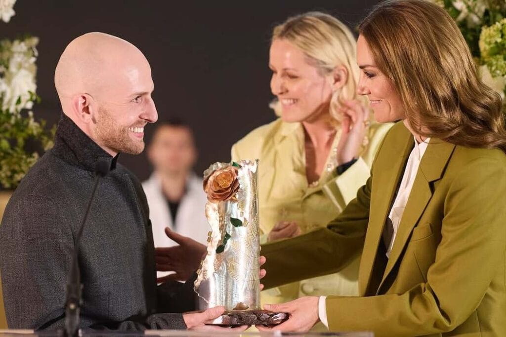 Kate Middleton presents designer Patrick McDowell with the Queen Elizabeth II Award